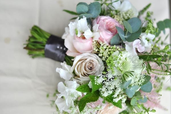 Soft pink blush grey and white wedding bouquet filled with early summer flowers including roses, sweetpeas, astilbe, eucalyptus and scabiosa.If you are getting married check out our seasonal flower guide on pinterest-www.pinterest.com/green_parlour