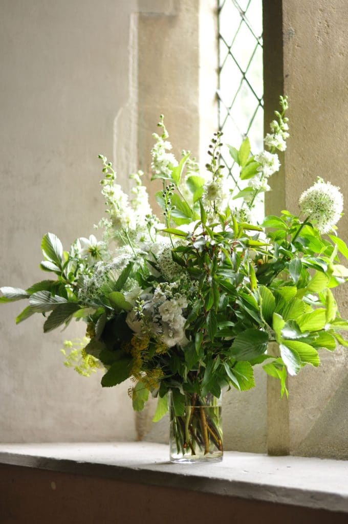 Country garden vase of wedding flowers in windowsill at a traditional church in Pangbourne, Berkshire