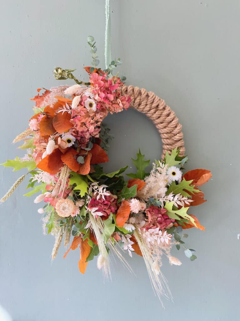 Dried flower autumn wreath in natural tones with grasses and seed heads with rope detail