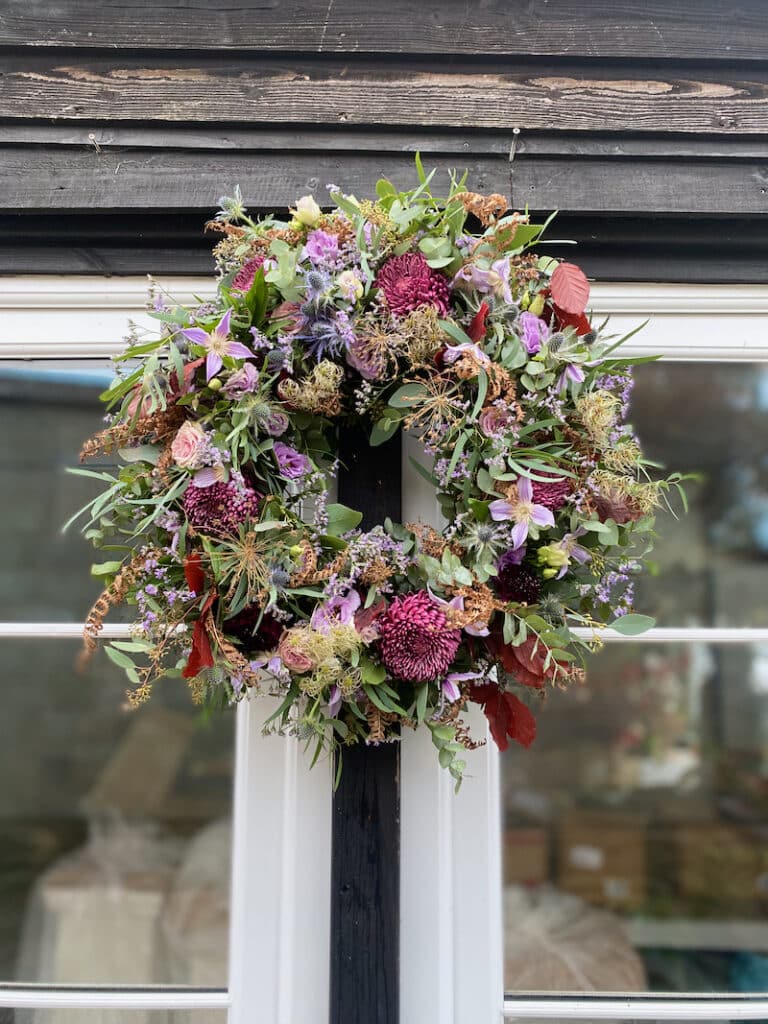 Elegant autumn wreath with roses, foliage, and romantic floral accents