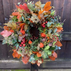Autumn wreath with golden leaves, textured foliage, and seasonal accents