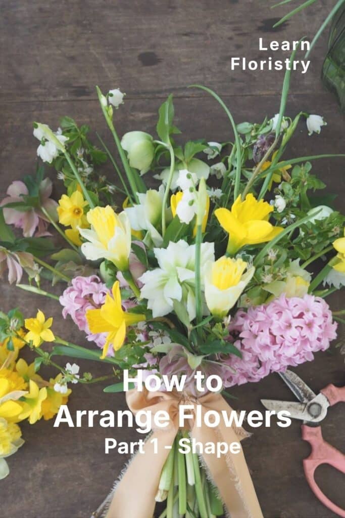 arranging flowers on a workbench where the florist is teaching flower arranging skills