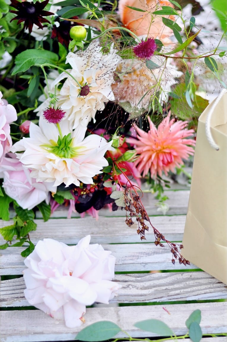 Florist arranging flowers on a wooden workbench